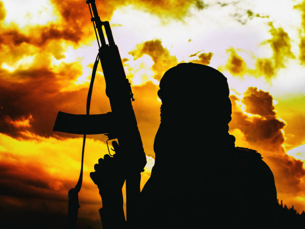 Soldier silhouette against a dramatic sunset sky
