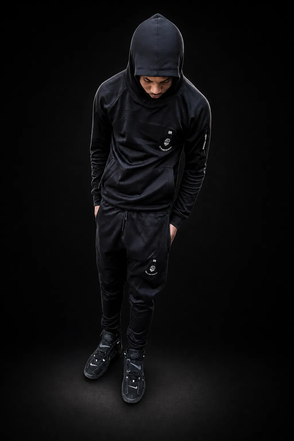 E4R model in all-black hoodie tracksuit set